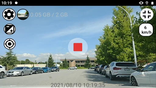 Drive Recorder dash cam app recording parking lot with red record button, speed display and timestamp overlay